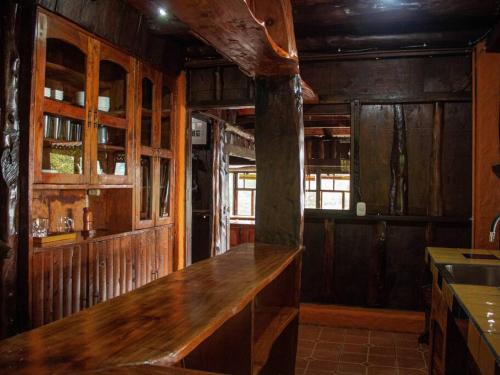 a kitchen with a wooden counter in a room at La Cabaña - Parque Eólico in Santa Ana