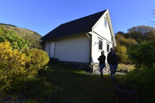 two people walking in front of a house at Guesthouse in Manger, Radøy Island in Kollstad