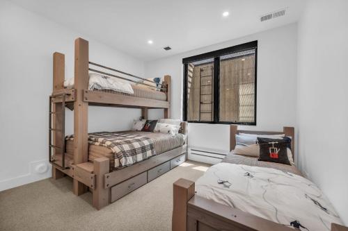 a bedroom with two bunk beds and a bed at Ridgeline Ski in Townhouse wHot Tub in Park City