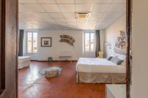 a bedroom with a large bed and a room with a couch at iFlat Trevi Fountain's roomy&friendly apartment in Rome