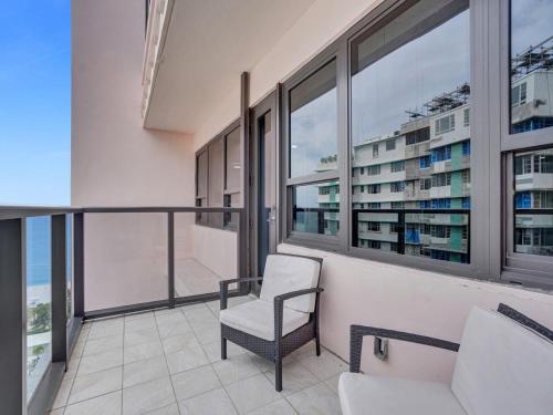 a balcony with a chair and some windows at Gorgeous Miami Beach Condo Beach Service 1614 in Miami Beach