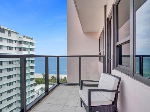 a balcony with a chair and a view of the ocean at Gorgeous Miami Beach Condo Beach Service 1614 in Miami Beach