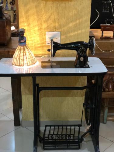 a sewing machine on a table with a light on it at Hotel Villa de Minas in Monte Sião