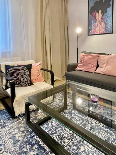 a living room with a couch and a glass table at Apartament KaMaRo in Słubice