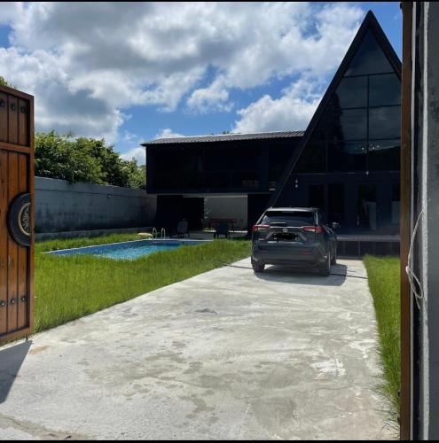 a car parked in front of a building at Qafqaz Wood Chalet in Gabala