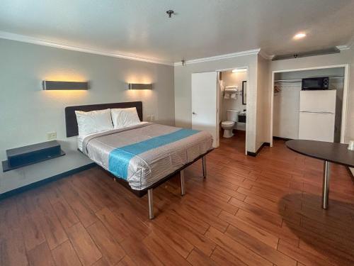 a bedroom with a bed and a table in it at Motel 6 Ontario CA Convention Center Airport in Ontario
