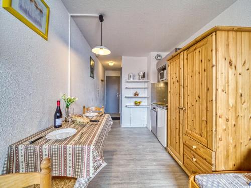 a kitchen with a table with a bottle of wine on it at Apartment Vanoise-12 by Interhome in Val Thorens