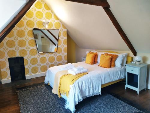 a bedroom with a bed and a mirror on the wall at The Shire House in Lostwithiel