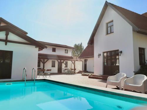 a house with a swimming pool in front of a house at Apartment Rügen by Interhome in Dargun