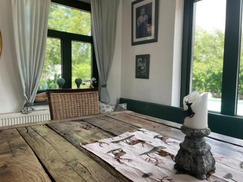 a room with a wooden table with a candle on it at Apartment Rügen by Interhome in Dargun