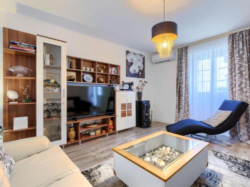a living room with a couch and a tv at Holiday Home Centar by Interhome in Umag