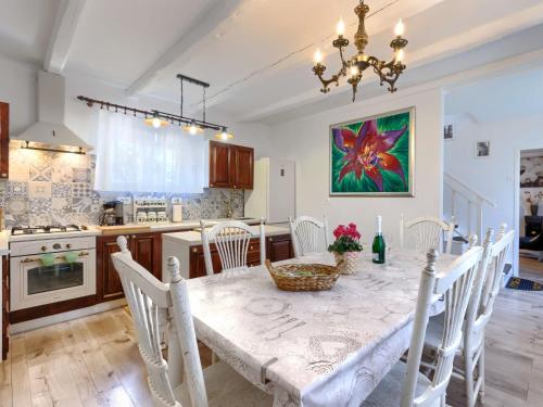 a kitchen and dining room with a table and chairs at Holiday Home Centar by Interhome in Umag