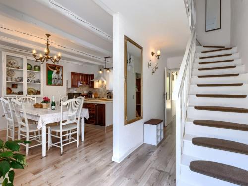 a kitchen and dining room with a table and a staircase at Holiday Home Centar by Interhome in Umag