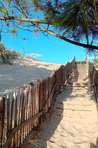 a fence on the beach next to a sandy beach at Apartment Patguyflor-2 by Interhome in Mimizan-Plage