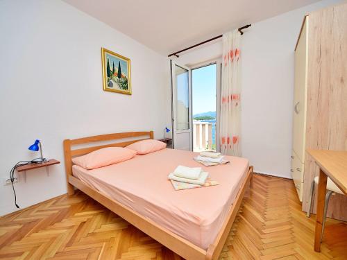 a bedroom with a bed and a large window at Apartment Jelka-2 by Interhome in Trstenik