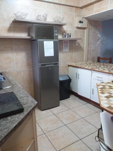 a kitchen with a refrigerator and a counter top at Afsaal Holiday Flats in Amanzimtoti