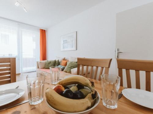 a table with a bowl of fruit on top of it at Apartment Stubner Kogel Top 18 by Interhome in Bad Gastein