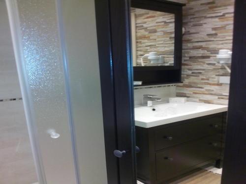 a bathroom with a sink and a mirror at Visnja Apartment in Kopaonik