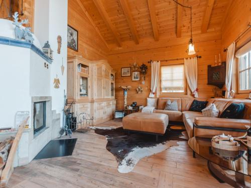 a living room with a couch and a fireplace at Chalet Königsleiten 3 by Interhome in Königsleiten