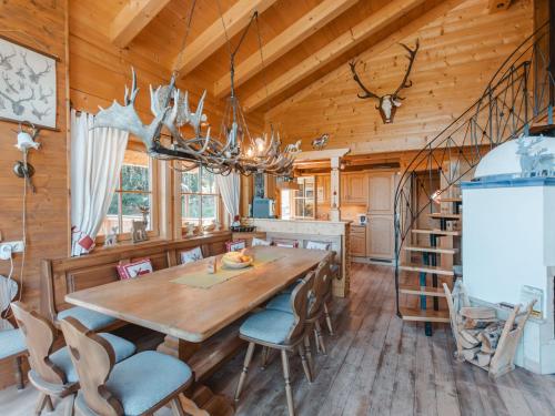 a dining room with a wooden table and chairs at Chalet Königsleiten 3 by Interhome in Königsleiten