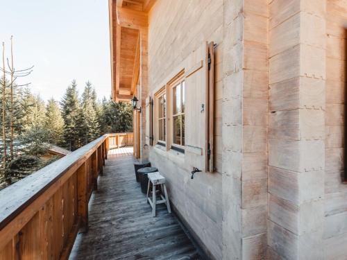 a wooden porch with a bench on the side of a building at Chalet Königsleiten 3 by Interhome in Königsleiten