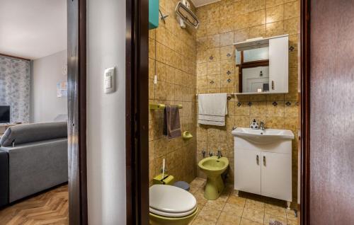 a small bathroom with a toilet and a sink at Apartments Drazen in Crikvenica
