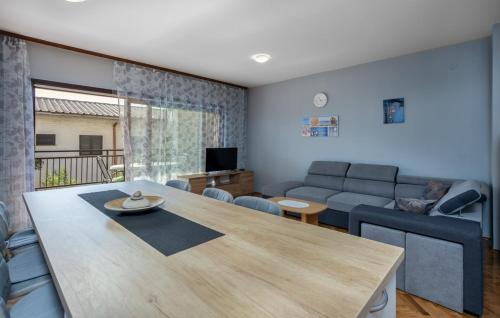 a living room with a table and a couch at Apartments Drazen in Crikvenica