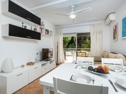 a kitchen and living room with a table and chairs at Apartment Jardines Del Mar by Interhome in Marbella