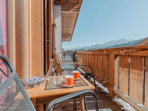 a table and chairs on the balcony of a house at Apartment Hajenuis TOP OG by Interhome in Königsleiten