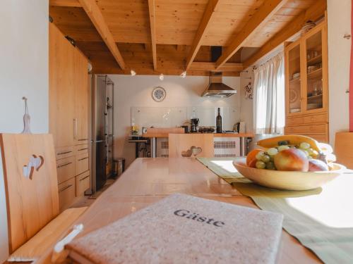 a kitchen with a bowl of fruit on a table at Apartment Hajenuis TOP OG by Interhome in Königsleiten