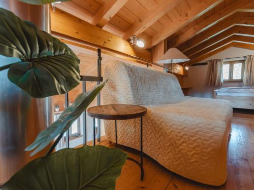 a bedroom with a bed and a table and a plant at Apartment Hajenuis TOP OG by Interhome in Königsleiten