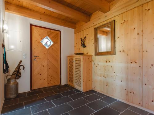 a room with a wooden door and a tiled floor at Apartment Hajenuis TOP OG by Interhome in Königsleiten