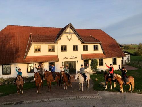 a group of people on horses in front of a building at Apartment Vilm by Interhome in Dargun