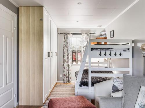 a small bedroom with a bunk bed and a couch at Holiday Home Villa Blommelund by Interhome in Kolmården
