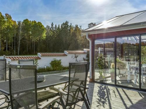 a patio with a table and chairs on a deck at Holiday Home Villa Blommelund by Interhome in Kolmården