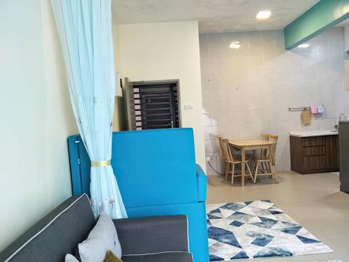 a living room with a blue couch and a table at MiahPuteh Cozy Homestay Cameron Highlands Pasar Malam in Brinchang