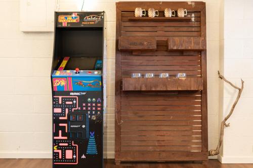 a video game machine next to a wall at Large Spanish Villa -Hot tub- Pool -Gym- Game Room in Sedona
