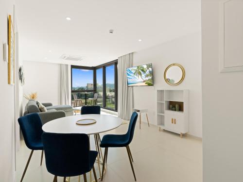 a living room with a table and chairs at Fourteen at Mullet Bay in Cupecoy