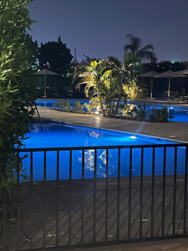 a view of a swimming pool at night at Luxury stay roof top in 6th Of October