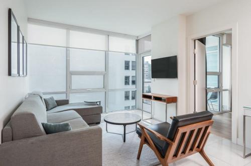 a living room with a couch and a table at Level Downtown LA South Olive in Los Angeles