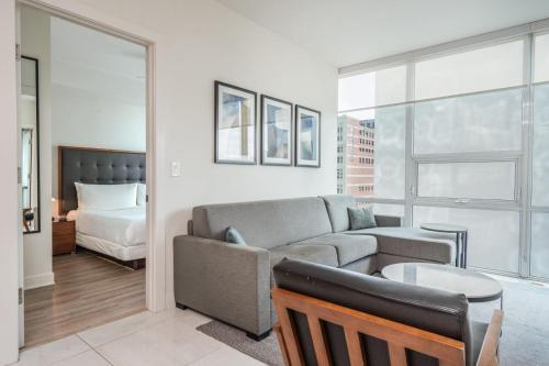a living room with a couch and a bed at Level Downtown LA South Olive in Los Angeles