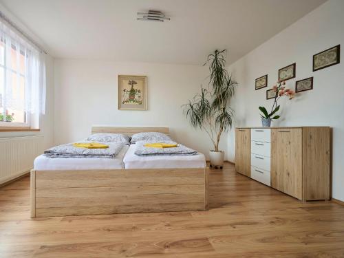 a bedroom with a large bed and a wooden cabinet at Apartment Formanka by Interhome in Liberec