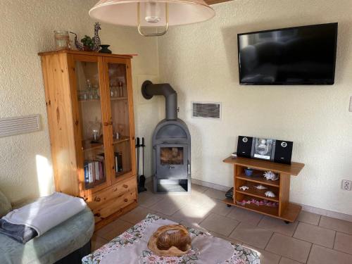 a living room with a wood stove in the wall at Holiday Home Am Walde-2 by Interhome in Dobbertin