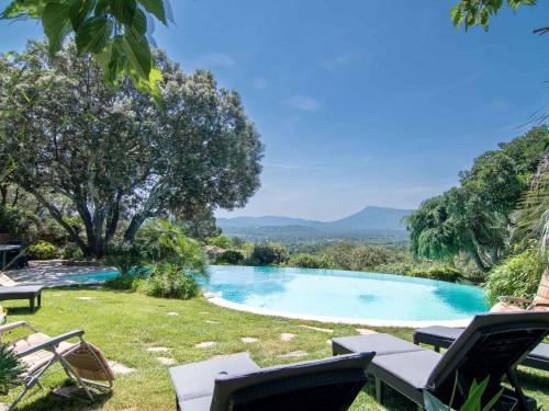 uma piscina com cadeiras e vista para as montanhas em Villa La Colline - GAR250 by Interhome em Garéoult