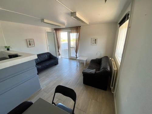 a living room with a couch and a table at Oasen Samsø in Nordby