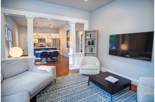a living room with a couch and a table at Chic Downtown Farmhouse with Garden and BBQ Grill in San Antonio