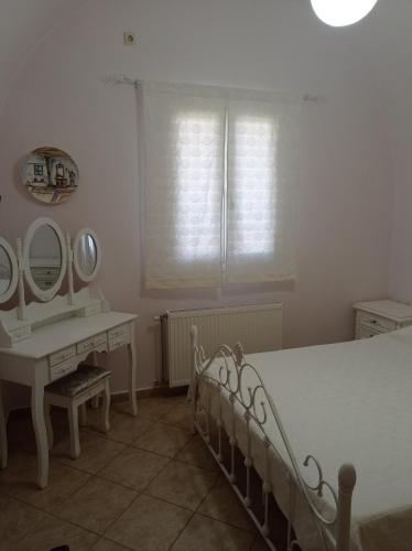 1 dormitorio con cama, lavabo y espejo en ANNA, en Kastrisiánika