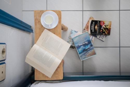 a book on a shelf with a plate and a book at Nefeli in blue in Plaka
