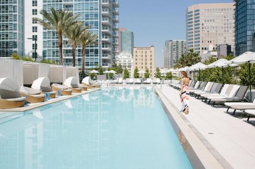 a woman and a child standing next to a swimming pool at Level Downtown LA South Olive in Los Angeles