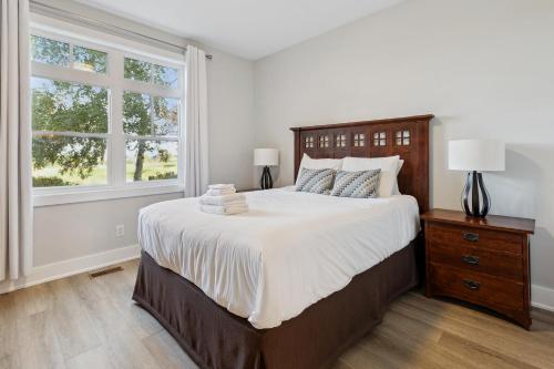 a bedroom with a large bed and a window at 2 Bedroom Condo only steps to the Village! in Blue Mountains